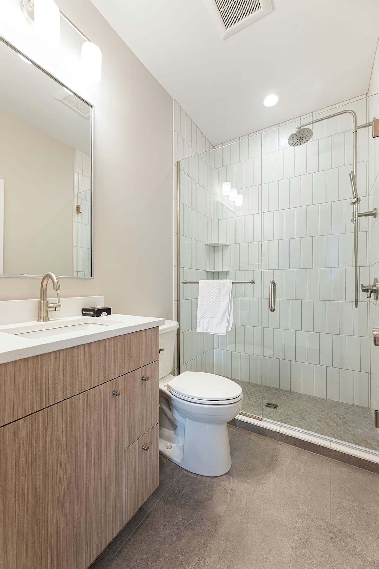 Bathroom with vanity, toilet, and glass shower