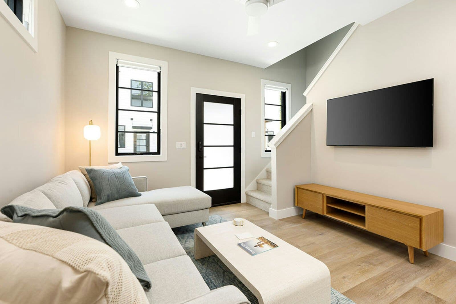 Living area with sectional, coffee table, and TV