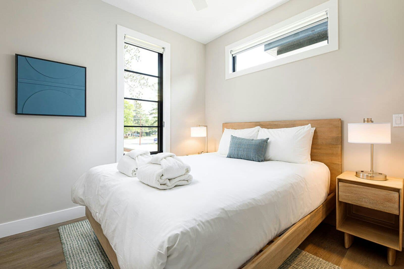 Wood-frame bedroom with robes and courtyard window
